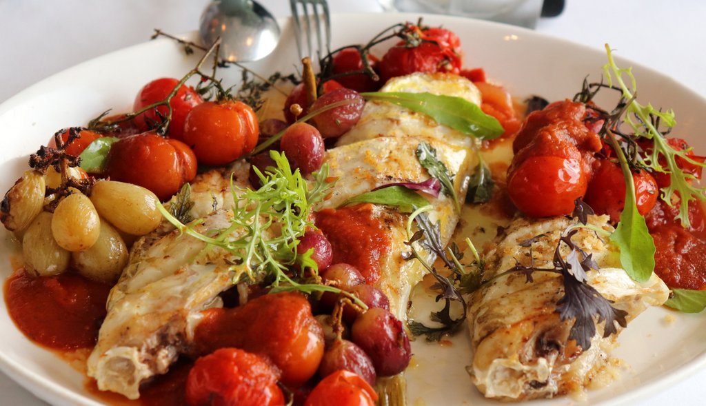 BREAM oven baked with walnuts, grapes and truss ripened tomatoes infused with rosemary and garlic