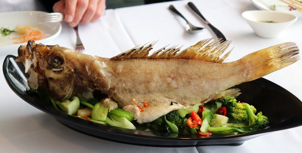 GROUPER steamed whole with fresh ginger, soy and oyster sauce, served with wild garlic and Asian greens