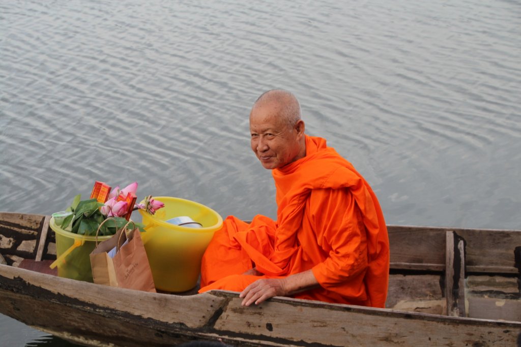 A tiny speck of orange in the front of a canoe was the first sign of the monk's approach. 