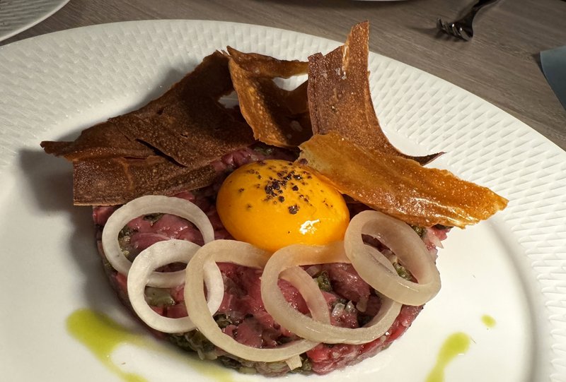 Aloria’s beef tartar with anchovy topped with a runny egg yolk